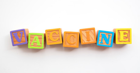 Vaccine word made from colourful wooden baby development blocks