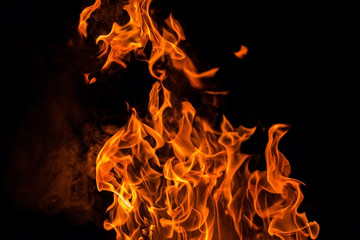Fire flame isolated over black background close up, abstract texture