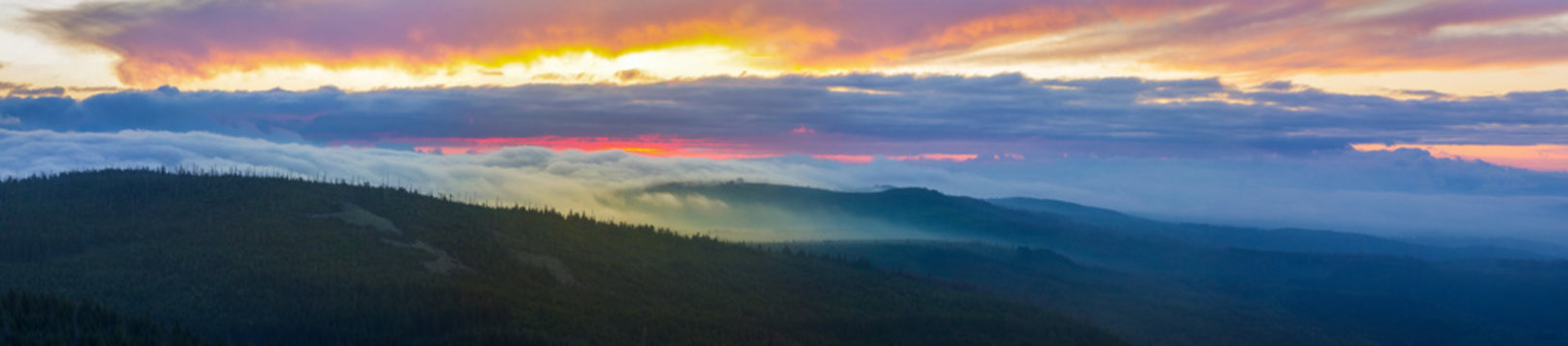 Calm view to the Steinfleckberg mountain in morning clouds, from the Lusen summit, in the Bavarian Forest, South Germany