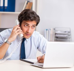 Young call center operator speaking on phone