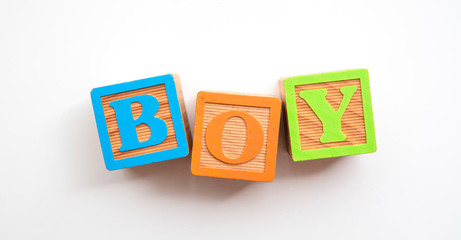 Boy word made from colourful wooden baby development blocks