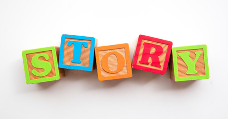 Story word made from colourful wooden baby development blocks