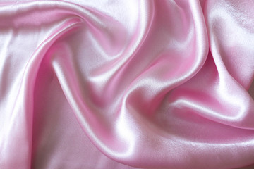 Smooth elegant pink silk or satin fabric background