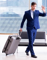 Businessman waiting at the airport for his plane in business cla