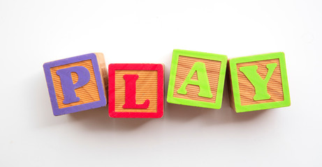 Play word made from colourful wooden baby development blocks