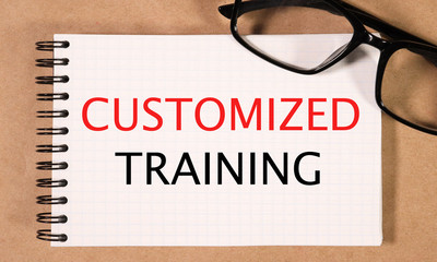 customized training. text on white paper on craft background near glasses