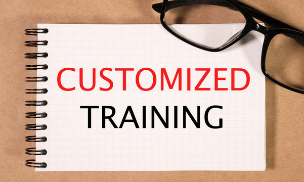 customized training. text on white paper on craft background near glasses