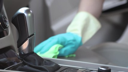 Car cleaning. Hands with a rag rub the surfaces of the passenger compartment and seats - Powered by Adobe