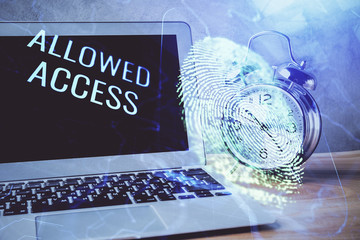 Computer on desktop in office with finger print drawing. Double exposure. Concept of business data security.