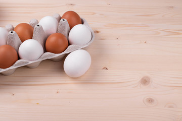 chicken raw eggs on the rustic wooden surface