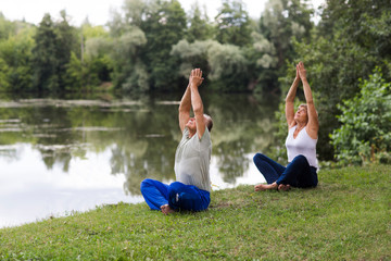 Senior family couple exercising and  doing their stretches outdoors. healthy lifestyle. Social Distancing. copy space. 