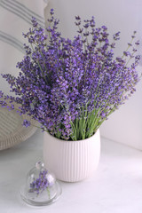 Beautiful lavender flowers on white table indoors