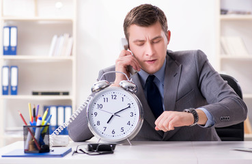 Businessman employee in urgency and deadline concept with alarm