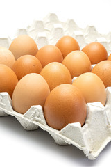 Chicken eggs in paper tray on white background. close-up. selective focus, soft focus.