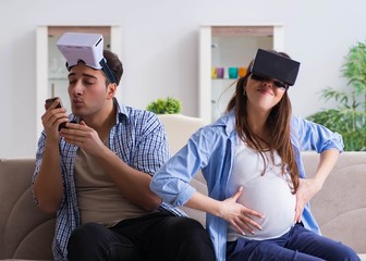 Young couple trying virtual reality glasses goggles