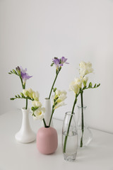 Beautiful spring freesia flowers on white table