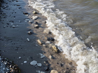 Waves, rocks, sand. Splashes of waves close-up