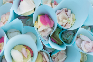 Blue paper bags with rose petals.