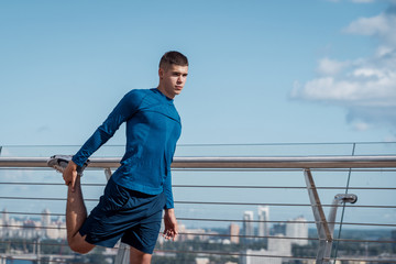 Young adult man making sport training outdoors alone