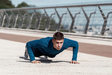 Fototapeta premium Young sportsman making sport training outdoors alone