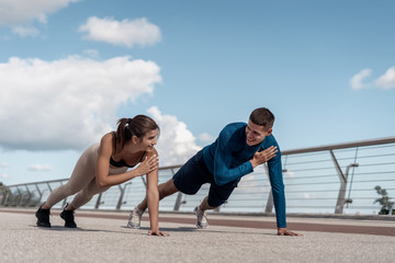 Man and woman making sport training outdoors together