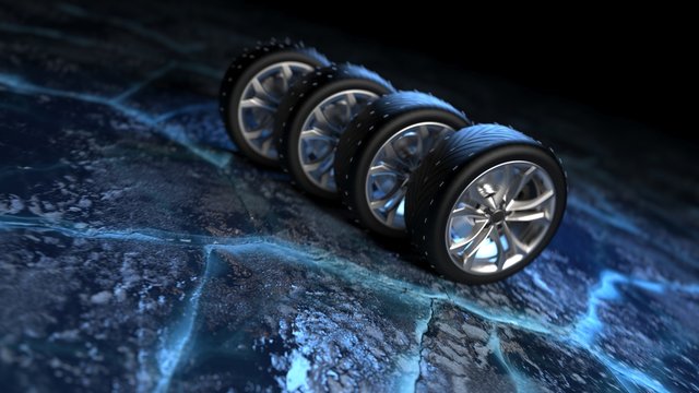 Winter tires on ice. car safety and driving concept.