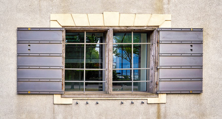 Fototapeta na wymiar Old wooden window with lattice and open shutters.