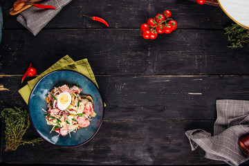 Salad on the decorated dark  wooden background 