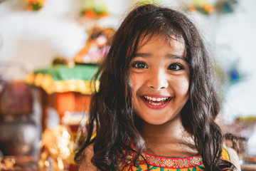 Portrait of indian female kid wearing sari dress - Southern asian child having fun smiling in front of camera - Childhood, different cultures and lifestyle concept