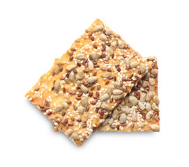 Delicious crispy crackers with different seeds isolated on white, top view