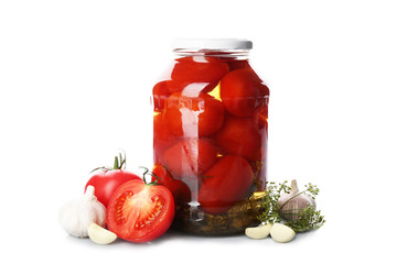 Jar of pickled tomatoes and fresh ingredients on white background