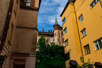 old architecture tower building medieval city street of Lviv Ukraine Europe historical town center landmark view foreshortening below