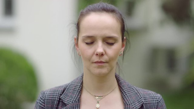 Face of a pretty girl who is closing and opening her eyes.