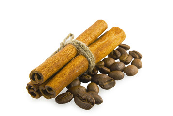 Cinnamon sticks to the left on coffee beans