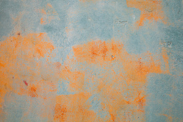 Old green grunge metal wall with rust spots, close-up