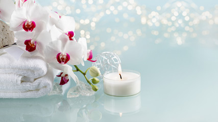 Spa or christmas decoration with white orchid and burning candle