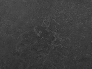 Granite stone wall black color rough surface texture material background