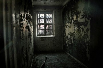 a cell in an abandoned asylum
