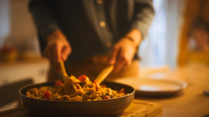 Person Serving Delicious Looking Pasta on the Plate. Serving Profesionally Cooked Pasta Dish in the Restaurant or for Romantic Dinner Meal at Home. Close-up Shot