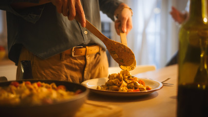 Person Serving Delicious Looking Pasta on the Plate. Serving Profesionally Cooked Pasta Dish in the Restaurant or for Romantic Dinner Meal at Home. Close-up Shot