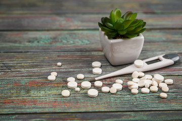 White pill on a wooden background with copy space.