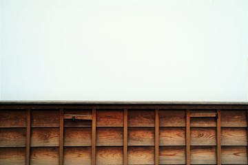 White wall and wood wall. Japanese old style outside wall around house. White and brown.