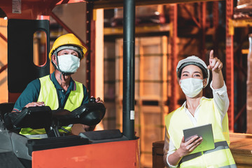Asian warehouse worker wear face mask as new normal after Covid 19