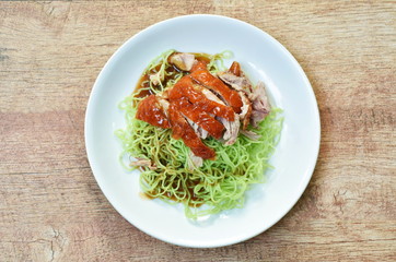 Chinese jade noodles topping slice roasted duck dressing sweet soy sauce on plate