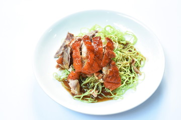 Chinese jade noodles topping slice roasted duck dressing sweet soy sauce on plate