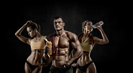 Obraz na płótnie Canvas group of threesome man with woman bodybuilders