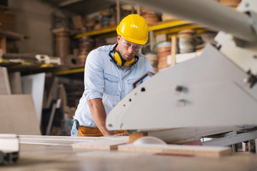 Carpenter using wood processing machine