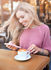 Beautiful woman with cup of hot drink outdoors. Autumn concept.