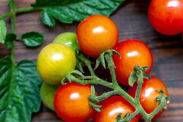 Naklejka na ściany i meble cherry tomatoes on wooden table background