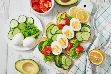 Grain bread sandwiches for breakfast, snacks toasts avocados, eggs, tomatoes, cucumbers. Keto diet. Healthy eating and food, dieting, vegan vegetarian, cleansing. Delicious breakfast or lunch